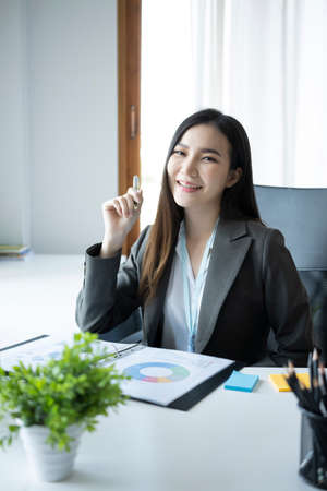 Pleased businesswoman working with modern device in office.の写真素材