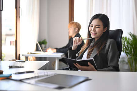 Beautiful asian woman entrepreneur working with computer in modern workplace.の写真素材