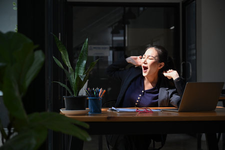 Overjoyed business woman raising hands up to celebrating her success.の写真素材