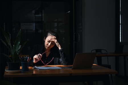 Young asian business woman suffering stress working at office.の写真素材