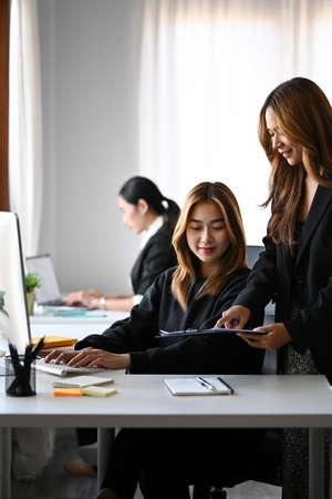 Two asian businesswomen working together at office.の写真素材