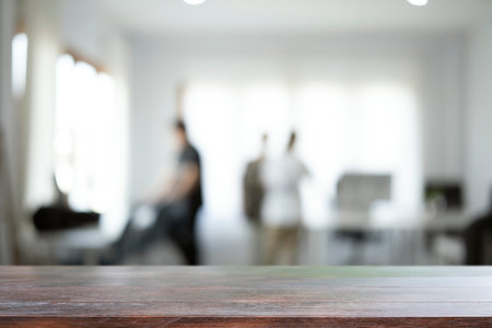Empty wooden table with blurred modern office background. Copy space for display of product.