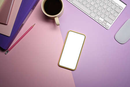 Top view smart phone, notebook and coffee cup on pink background.