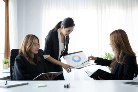 Businesswoman explaining financial information to her colleagues.