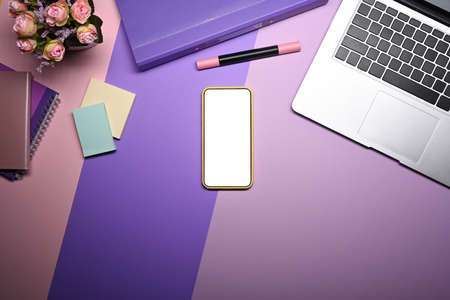 Mock up smart phone, laptop computer and notebook on purple background.