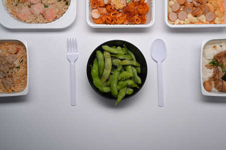 Frozen edamame soybeans in round bowl on white background.の写真素材