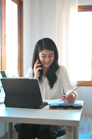 Businesswoman analyzing financial data on computer tablet.の写真素材