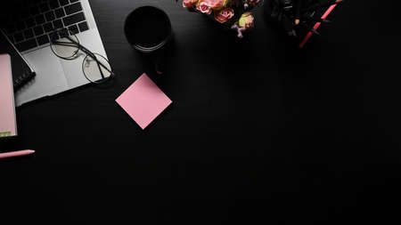 Above view computer laptop, coffee cup ,cactus and supplies on black table.の写真素材