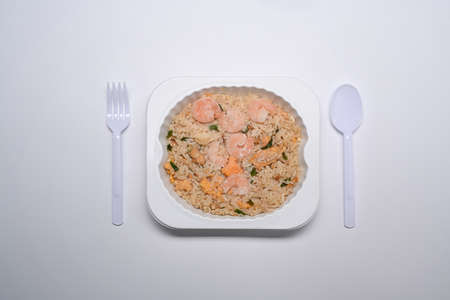 Flat lay, Frozen fried rice with shrimp on white background.の写真素材