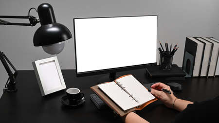 Man freelancer sitting at comfortable home office and working with computer.
