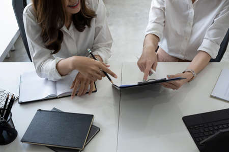 Above view businesspeople analyzing financial document together.の写真素材