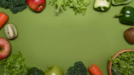 Fresh assorted fruits and  vegetables on green background. Healthy food concept.の写真素材