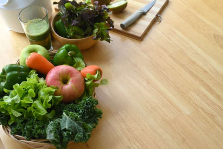 Fresh green detox vegetable juice, blended and organic vegetables on wooden table.