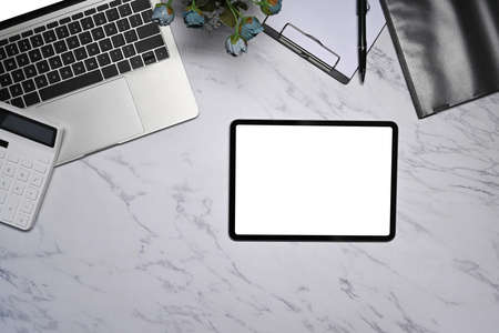 Top view digital tablet, laptop computer, coffee cup and calculator on marble background.
