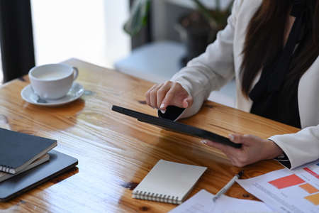 Pleased beautiful business woman working at modern office.の写真素材