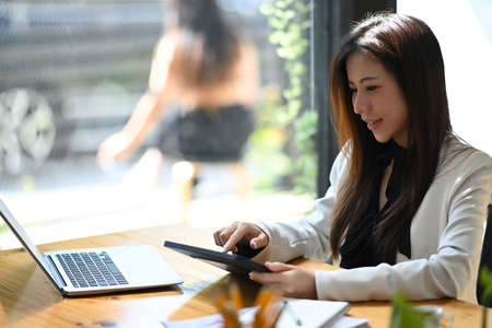 Close up view businesswoman checking email on digital tablet.の写真素材