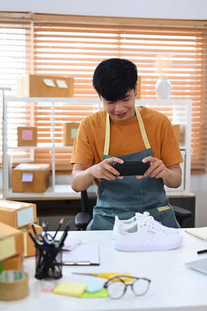 Young start up small business entrepreneur preparing parcel boxes for delivery.の写真素材