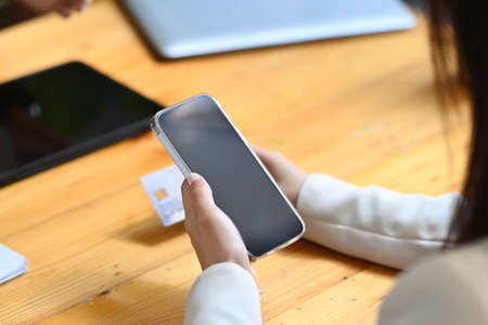 Beautiful asian woman holding credit card and shopping online with computer tablet.