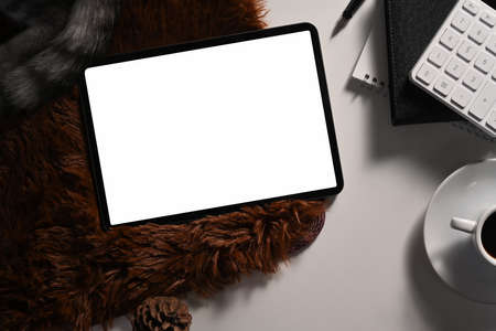 Digital tablet, coffee cup and supplies on white table. Top view.の写真素材