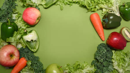 Various organic vegetables and fruits on green background.の写真素材