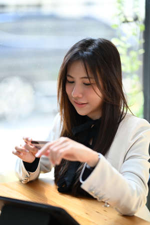 Beautiful asian woman holding credit card and shopping online with computer tablet.の写真素材