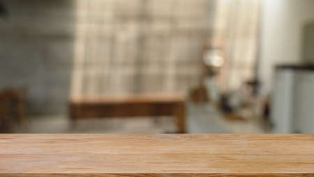 Wooden table in front of  blurred background of living room. Copy space for display or montage your products.の写真素材