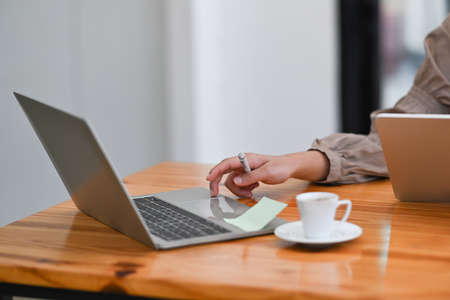 Confident asian woman entrepreneur using digital tablet at her workplace.