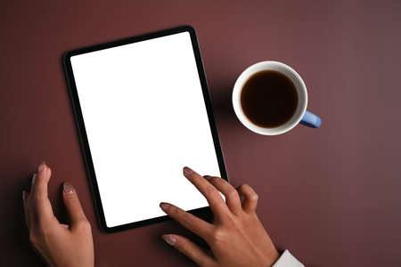 Above view woman hand typing on screen of digital tablet.