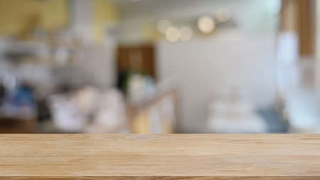 Empty wooden table in front of  blurred background of coffee shop. For display or montage your...