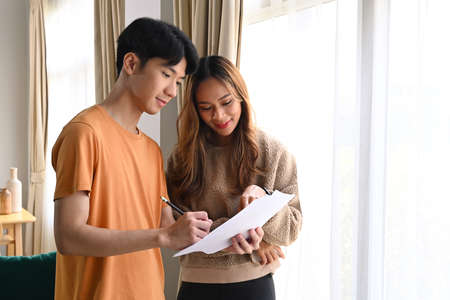 Two business partner reading some paperwork together at home office.の写真素材