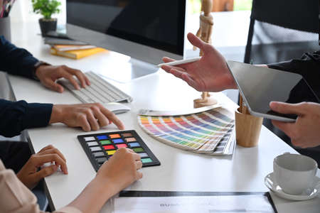 Group of graphic designers brainstorming and working on new project together.の写真素材