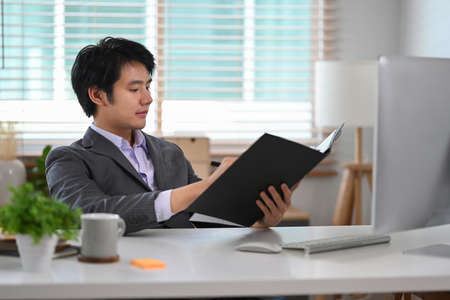 Young asian man startup business entrepreneur working at modern workplace.