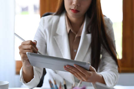 Financial advisor analyzing business data on digital tablet.の写真素材