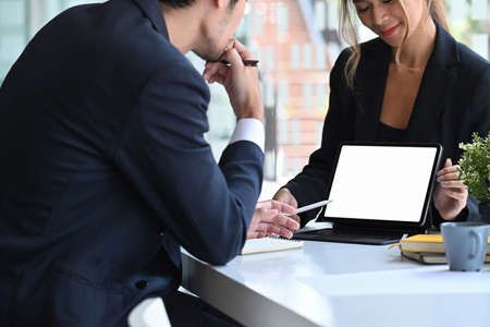 Confident female manager holding digital tablet and presenting new corporate strategy to her colleague.の写真素材