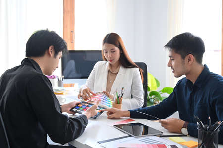 Team of interior designers brainstorming and working new project together at creative office.の写真素材