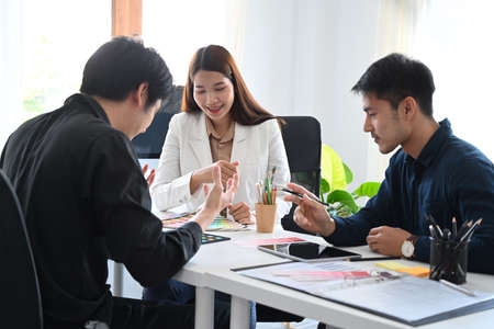 Group of creative people brainstorming and preparing presentation for company clients or investors.の写真素材