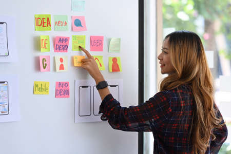 Ux designer planning new website wireframe at creative office.