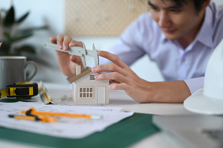 Asian engineer or architect working on architectural project at home office.の写真素材