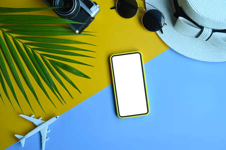 Top view of beach summer accessories with smart phone, camera, sunglasses and hat. Summer vacation...