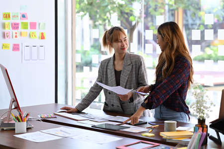 Website development team brainstorming and work together on mobile application software design project.の写真素材