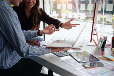 Graphic designers working with UX designer designing framework layout development project for mobile application at modern office.の写真素材