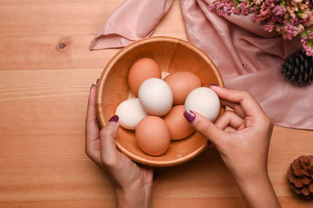 Colorful Easter eggs over pink background. Flat lay, top view, copy space.の写真素材