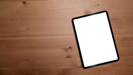 Mockup digital tablet with empty display on wooden background with copy space.の写真素材
