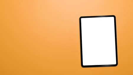 Mockup digital tablet with blank screen on yellow background with copy space. Top view, Flat lay.の写真素材
