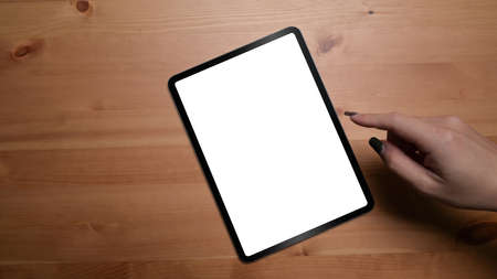 Digital tablet with empty screen on orange background with copy space. Top view, Flat lay.の写真素材