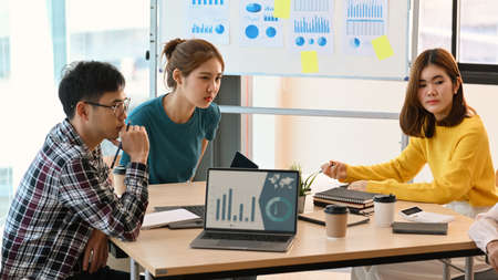 Overjoyed young diverse employees celebrating business success or victory together in office.