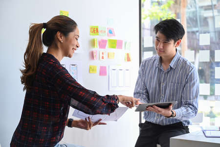 Two web developer are planning sketch, prototype, framework, layout app design project together.の写真素材