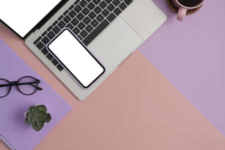 Flat lay mockup laptop computer, smartphone, glasses and coffee cup on two tone background.