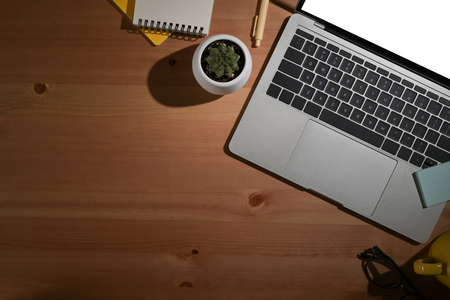 Laptop computer and office supplies on wooden background. Flat lay.の写真素材