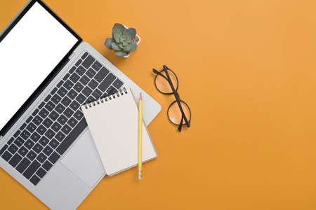 Pastel office desk with laptop computer, notebook and coffee cup. Flat lay, Top view with copy...